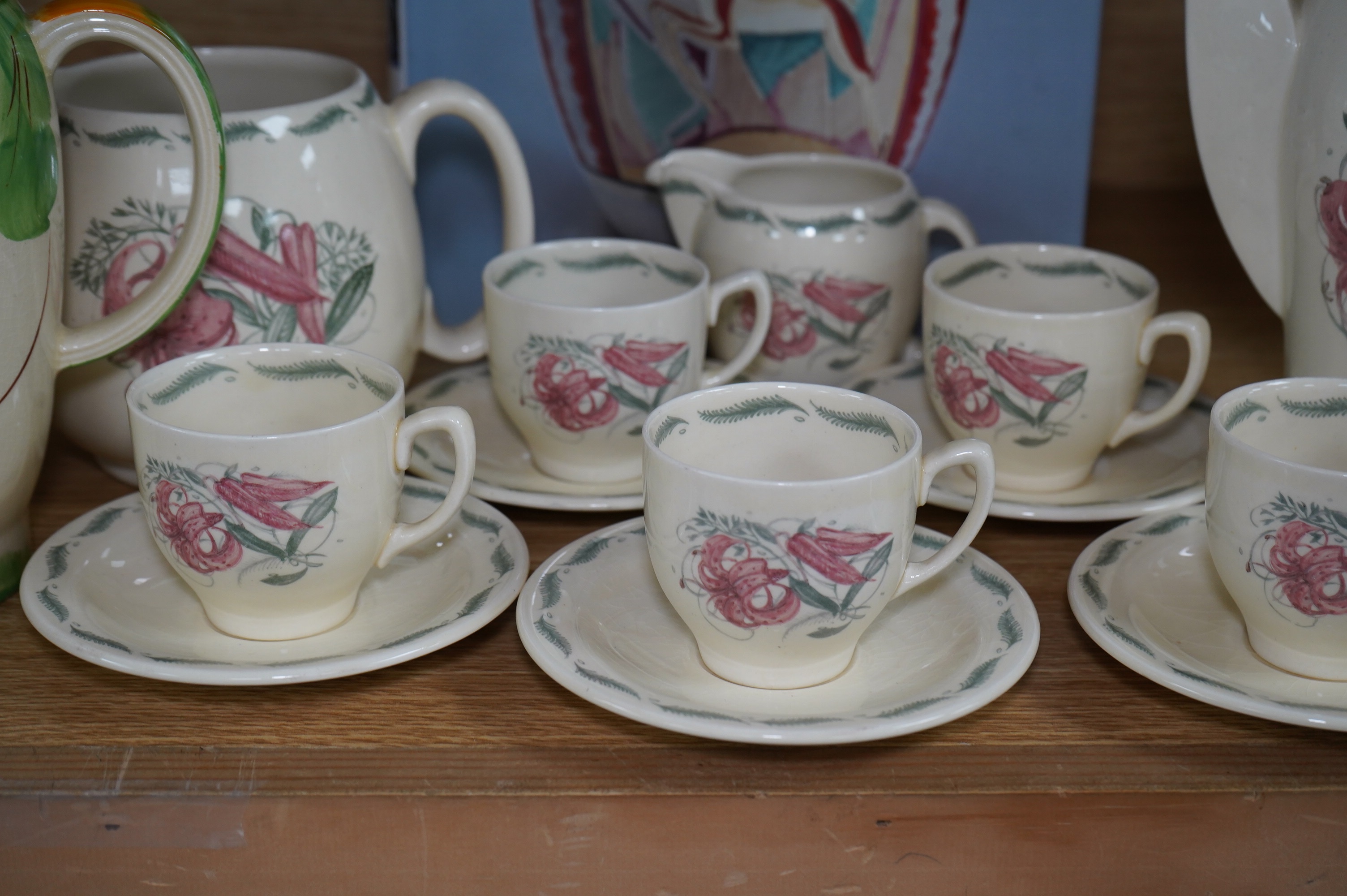 A Susie Cooper style 'Tiger Lily' pattern teaset, possibly by Wood & Co., a Susie Cooper reference book and a later painted Falcon shape coffee pot. Condition - good
